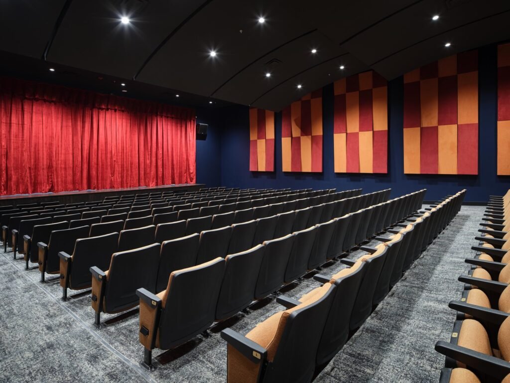 Theater auditorium with red stage curtain